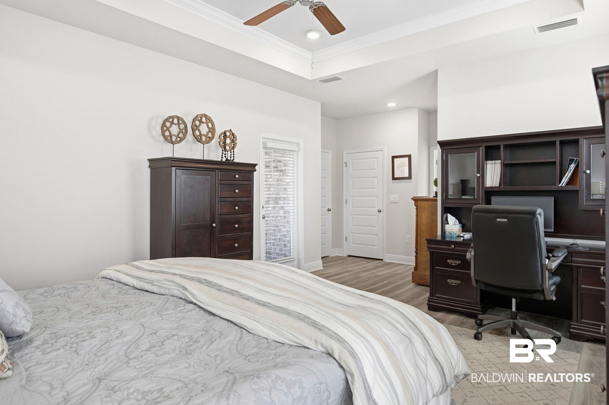 11123 Genuine Risk Circle Daphne, AL 36526 - Photo 27 of 67 Bedroom featuring crown molding, light wood finished floors, a raised ceiling, a ceiling fan, and an office area