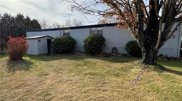 a view of a house with a yard and garage