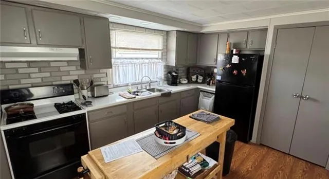 a kitchen with a sink stove and refrigerator