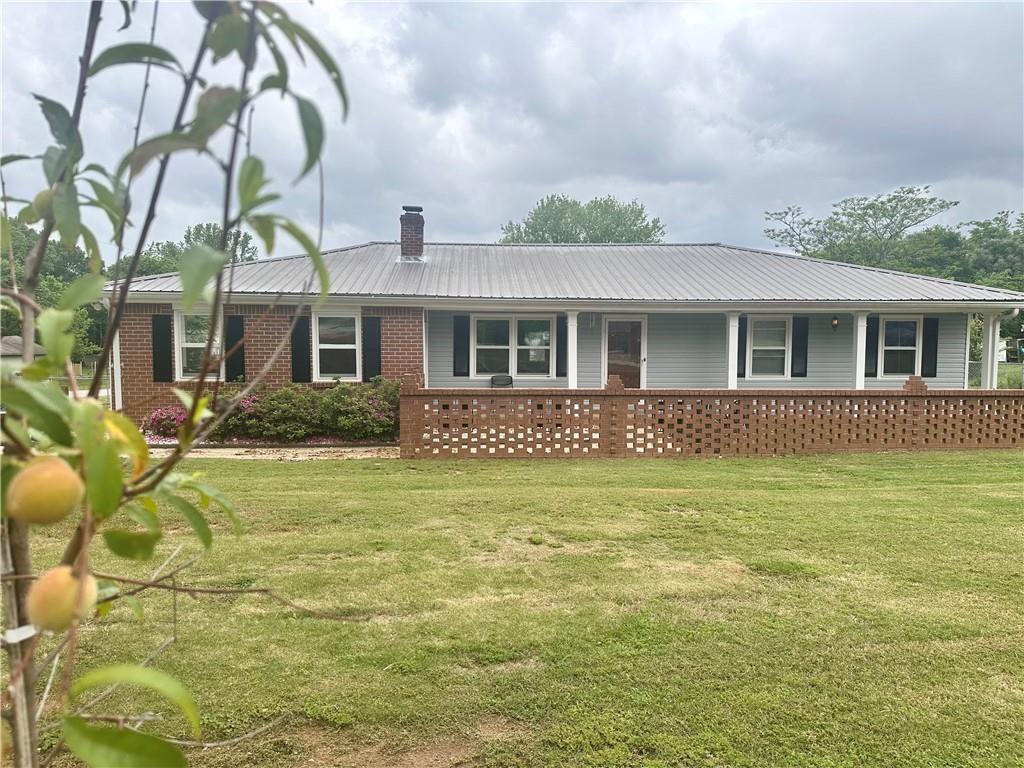 815 Tanner Road Dacula, GA 30019 - Photo 1 of 1 a front view of a house with a garden