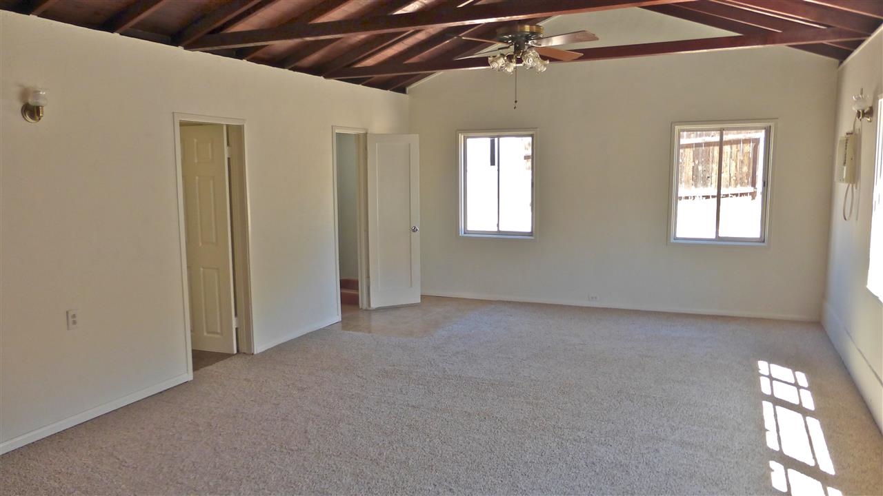 10455-59 Valle Vista Road Lakeside, CA 92040 - Photo 4 of 20 Large Living Room with Open Beamed Ceilings. Door leads to 3/4 bathroom.