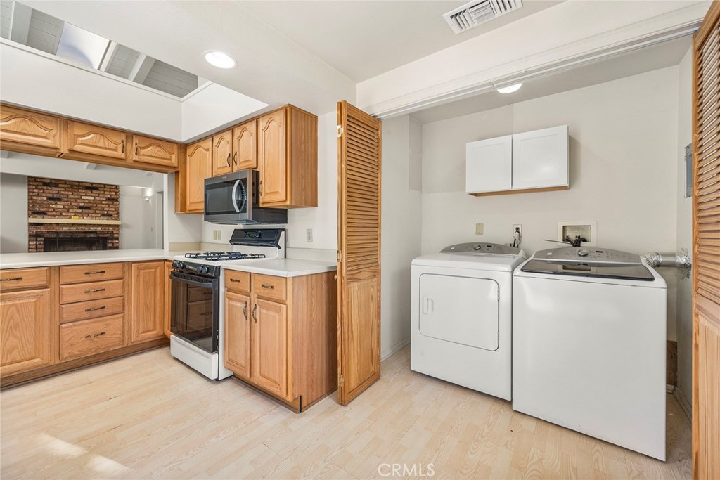 4821 Hampton Road La Canada Flintridge, CA 91011 - Photo 18 of 36 a kitchen with white cabinets and white appliances