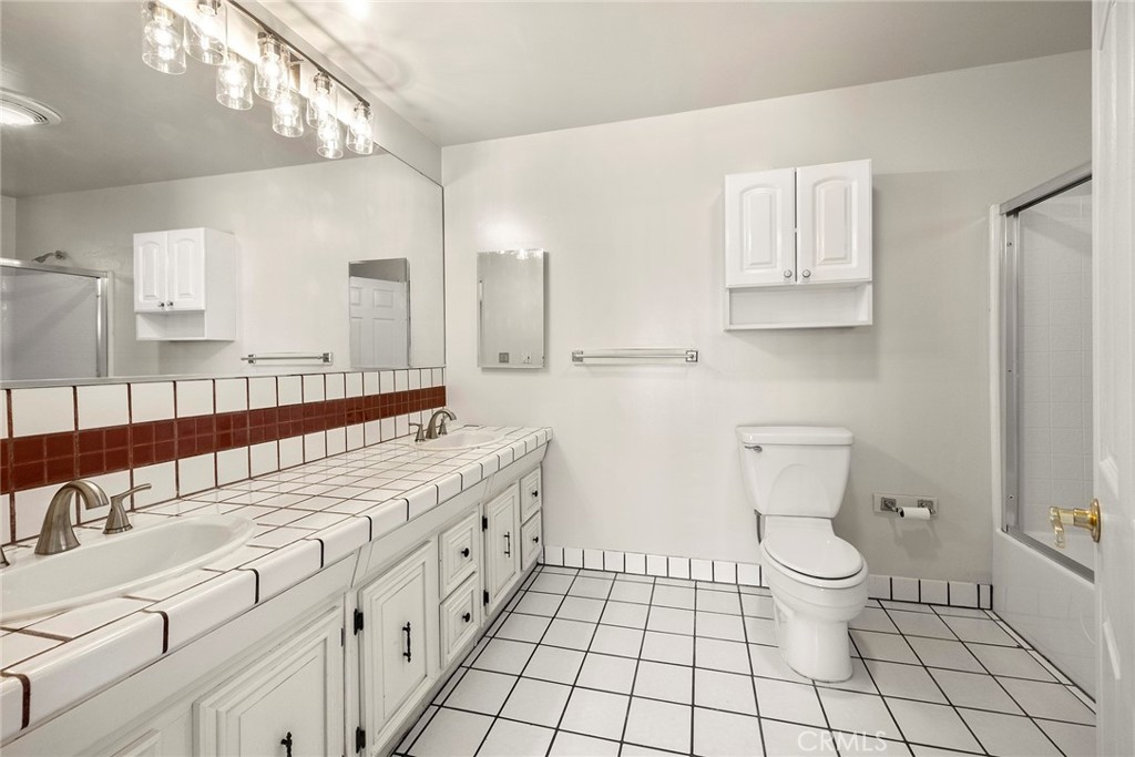 4821 Hampton Road La Canada Flintridge, CA 91011 - Photo 23 of 36 a spacious bathroom with a double vanity sink toilet and a mirror