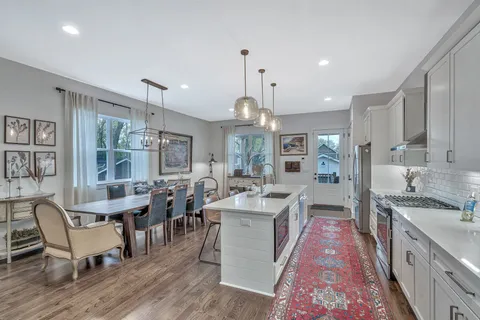 a large kitchen with lots of counter space and furniture