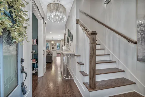 a view of entryway and hall with wooden floor