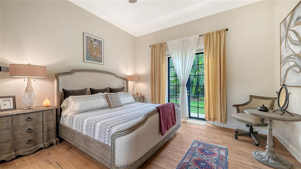 1630 Assisi Drive, Unit 18 Sarasota, FL 34231 - Photo 15 of 42 a bedroom with a bed a table and chair