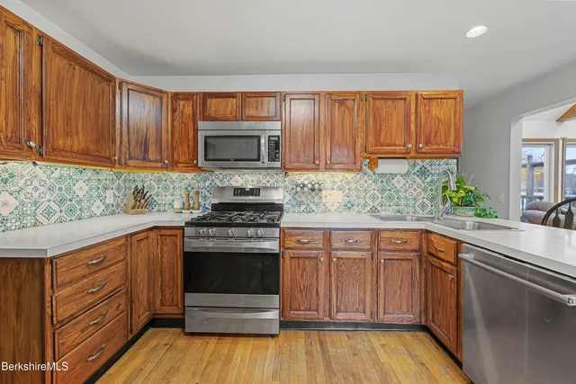 a living room with furniture a window and a flat screen tv