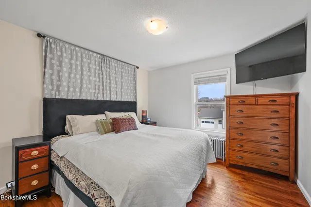 a bedroom with a bed and a dresser