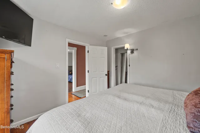 a bedroom with a bed and a television