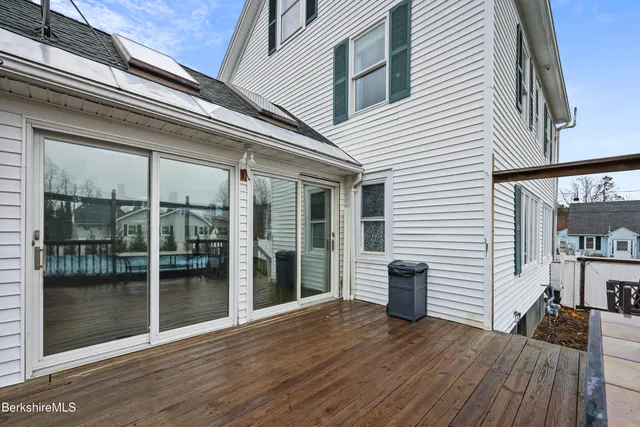 a view of a house with a big yard and large trees
