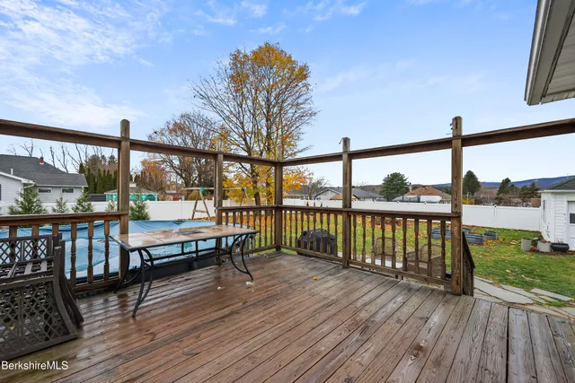 a view of a house with a yard and sitting area