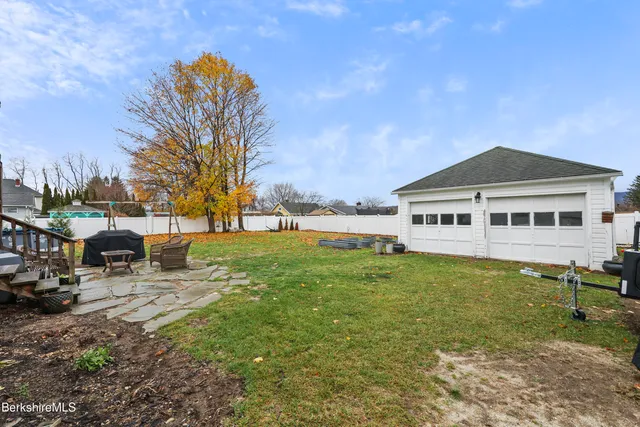 an aerial view of a house with garden space and street view