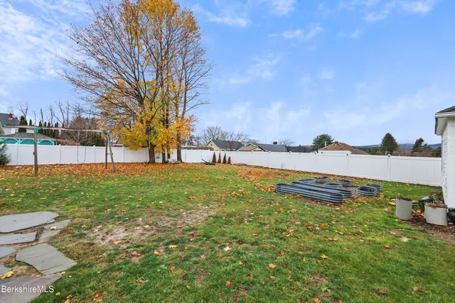 a aerial view of a house with backyard and outdoor seating