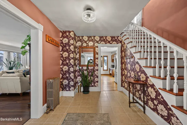 a living room with furniture a flat screen tv and a large window