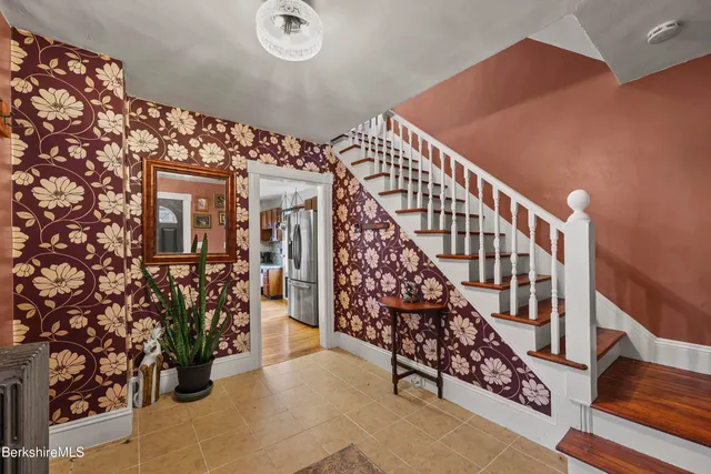 a living room with furniture floor to ceiling window and a flat screen tv