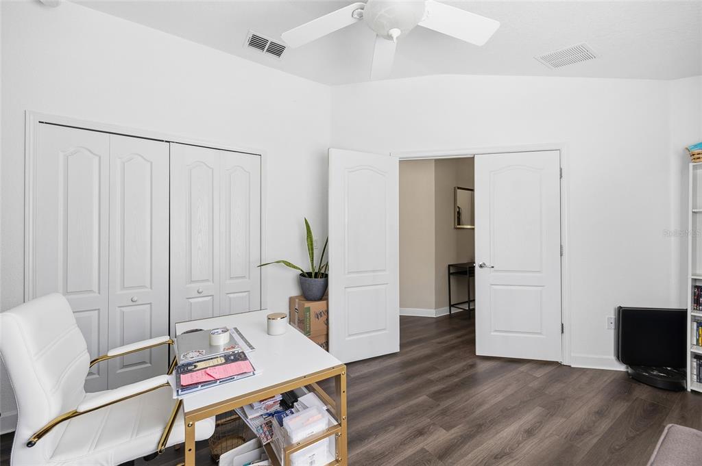 10019 Newminster Loop Ruskin, FL 33573 - Photo 20 of 34 a workspace with furniture and wooden floor