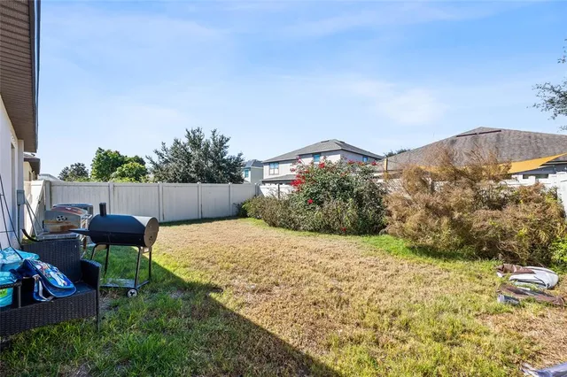 a backyard of a house with table and chairs