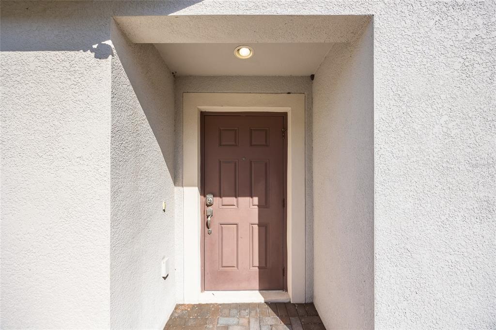 10019 Newminster Loop Ruskin, FL 33573 - Photo 5 of 34 a view of a hallway with wooden floor and entryway
