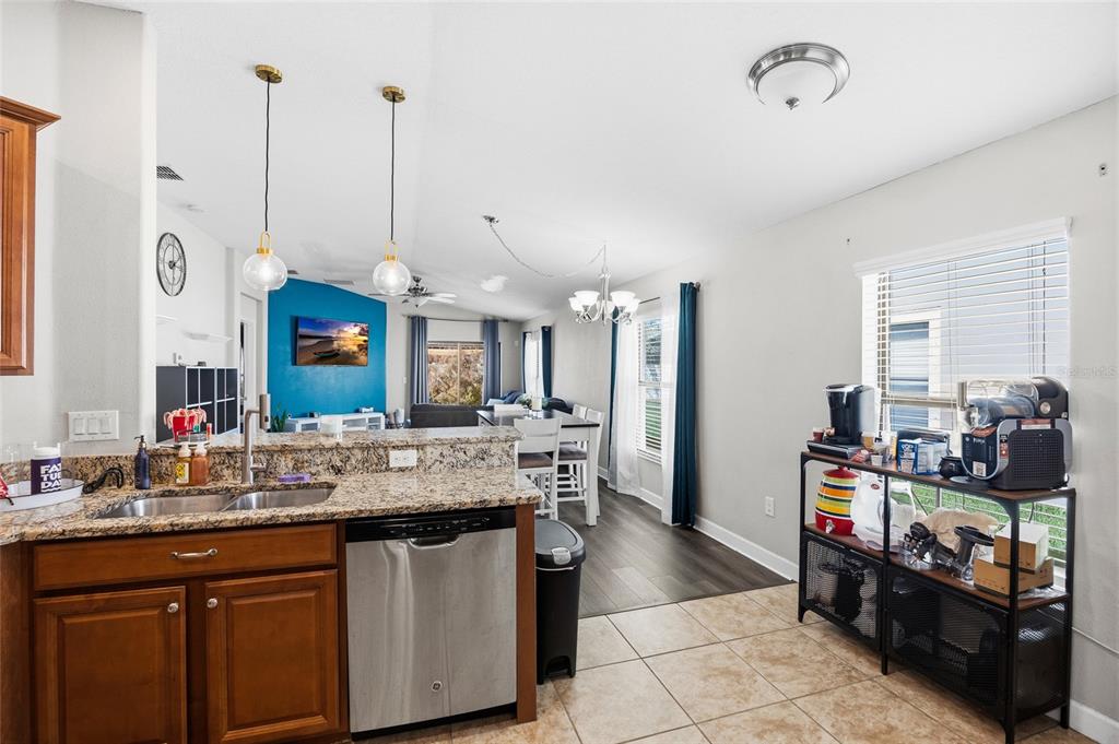 10019 Newminster Loop Ruskin, FL 33573 - Photo 7 of 34 a kitchen with stainless steel appliances granite countertop a stove a sink and a refrigerator