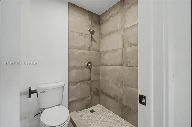 a bathroom with a toilet and a shower