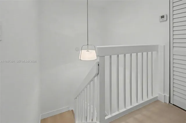 a view of a hallway with stairs