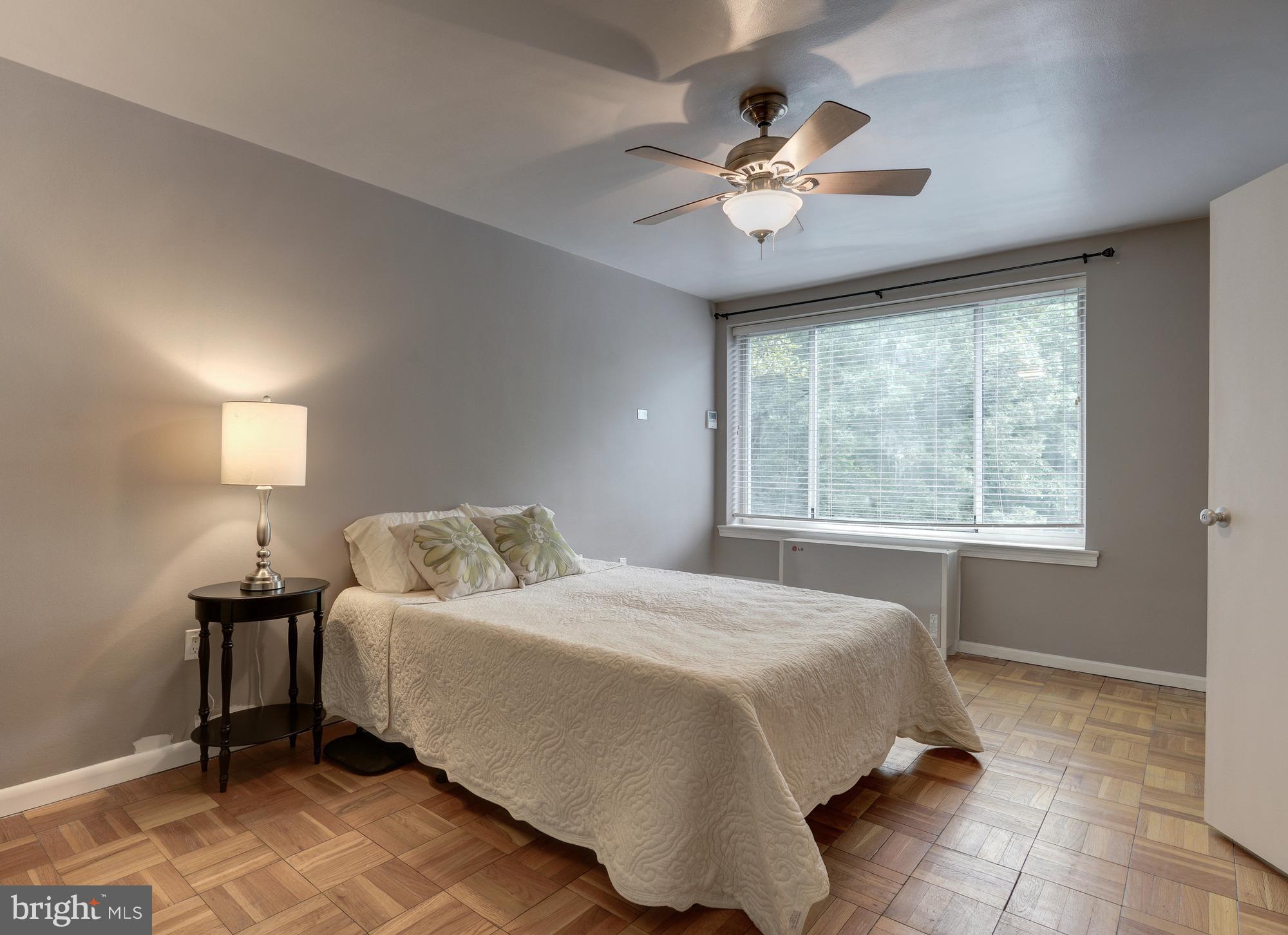4100 W Street Northwest, Unit 416 Washington, DC 20007 - Photo 15 of 32 a spacious bedroom with a bed and a chandelier
