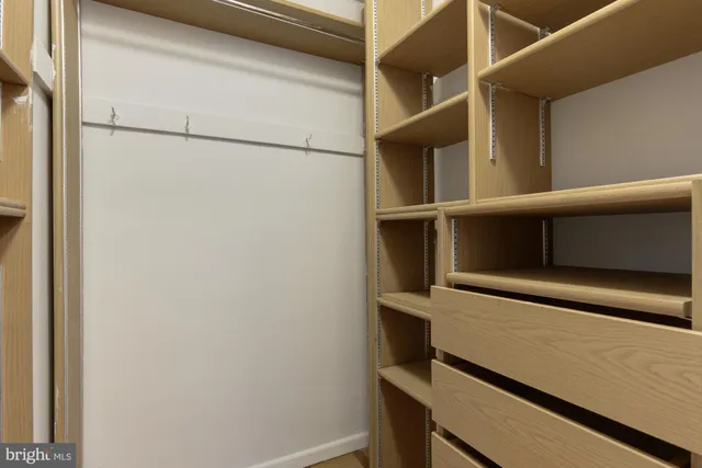 a view of a brick house with a yard and plants