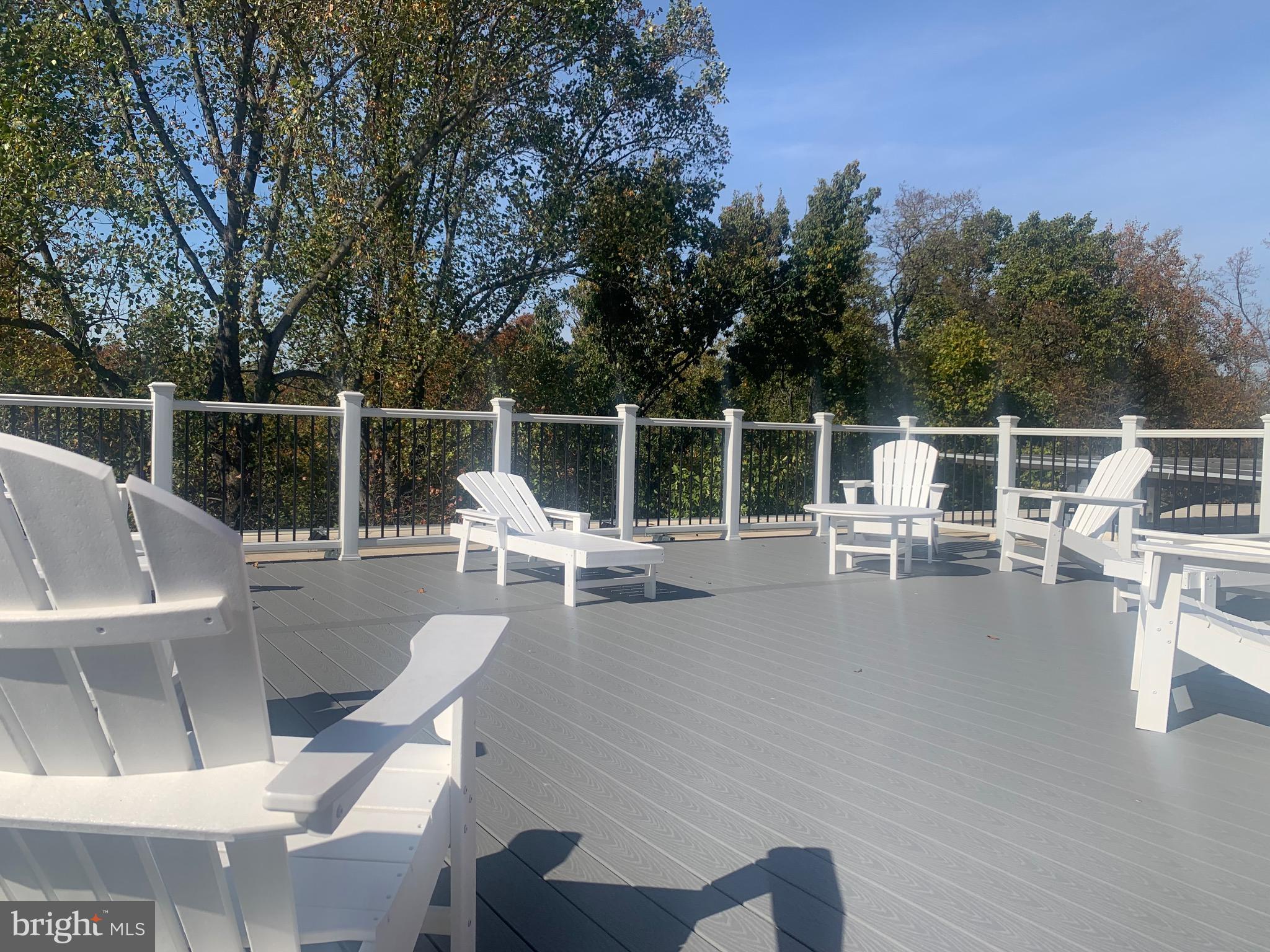 4100 W Street Northwest, Unit 416 Washington, DC 20007 - Photo 23 of 32 a view of roof deck with chairs and wooden floor