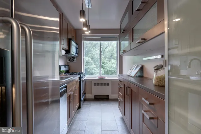 a kitchen with stainless steel appliances granite countertop a sink and a window
