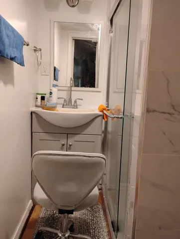 a bathroom with a sink a mirror and shower