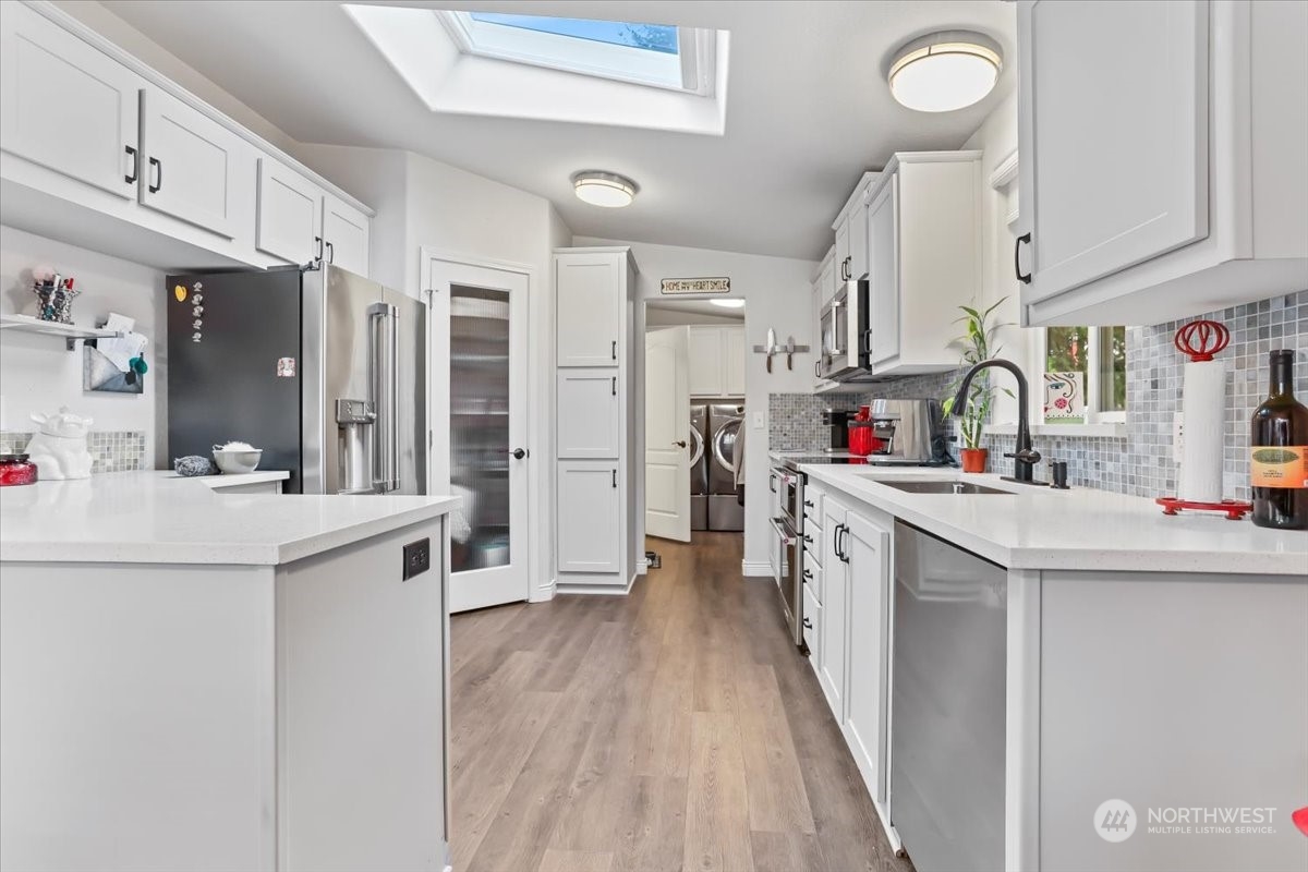 23825 15th Avenue Southeast, Unit 6 Bothell, WA 98021 - Photo 17 of 30 a kitchen with stainless steel appliances a sink stove and cabinets