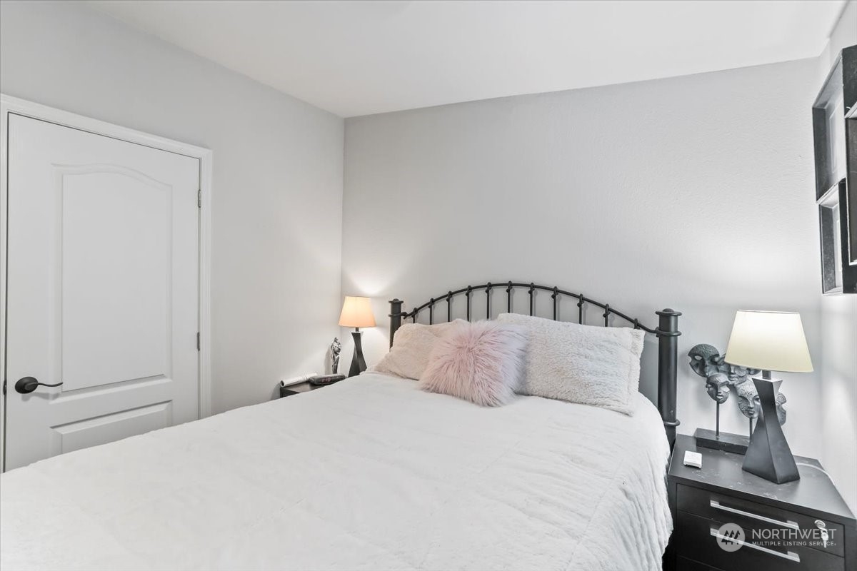 23825 15th Avenue Southeast, Unit 6 Bothell, WA 98021 - Photo 24 of 30 a bedroom with a bed and a lamp