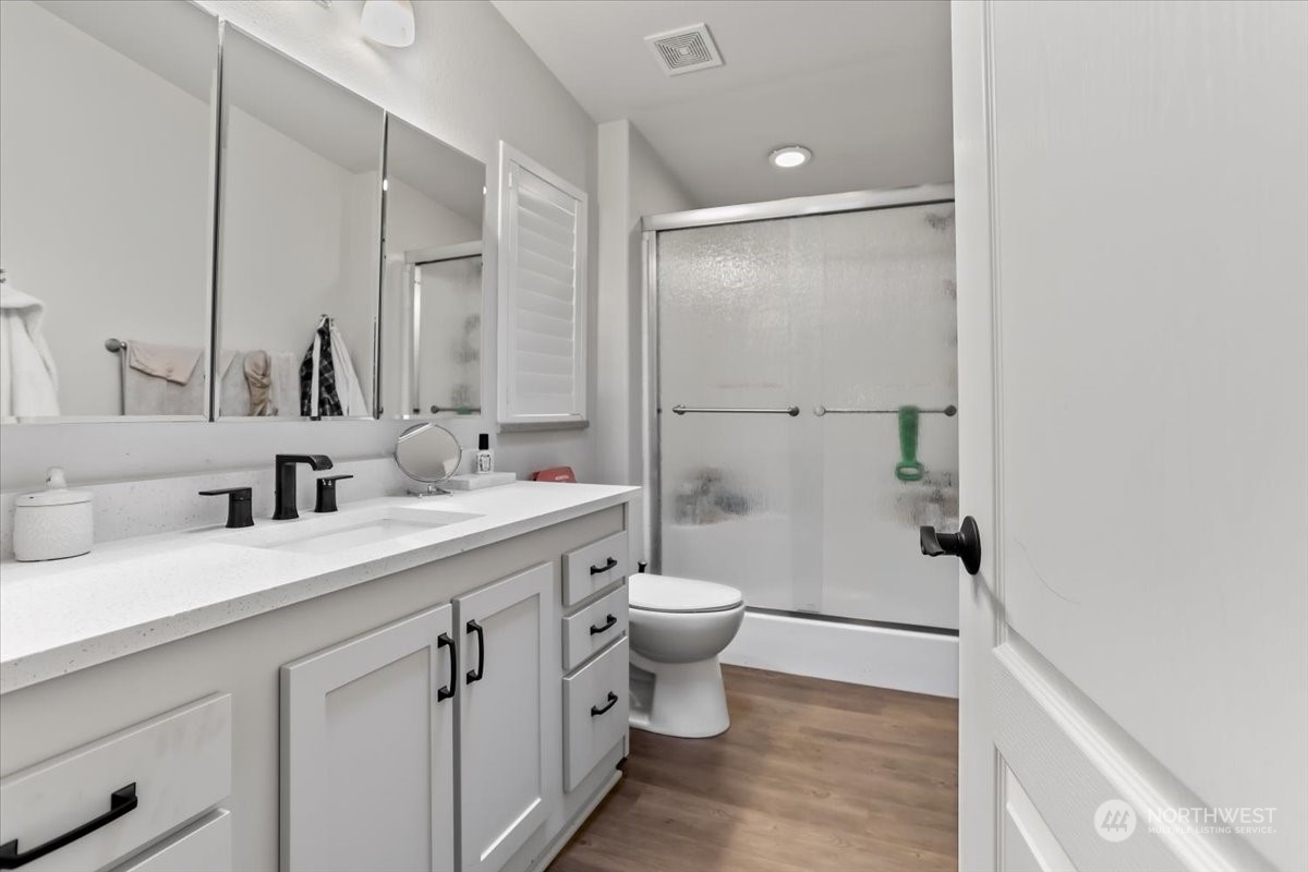 23825 15th Avenue Southeast, Unit 6 Bothell, WA 98021 - Photo 25 of 30 a bathroom with a double vanity sink mirror and toilet