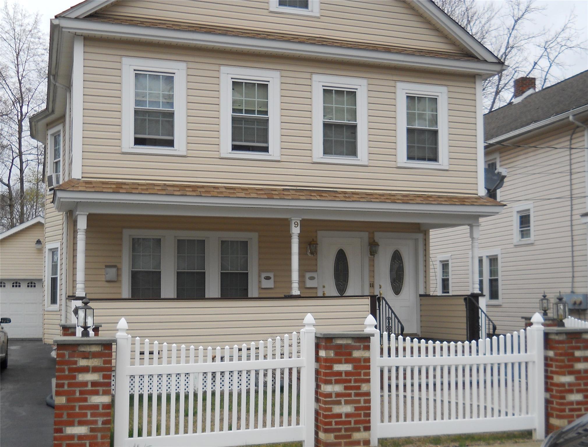 a view of a brick house with large windows
