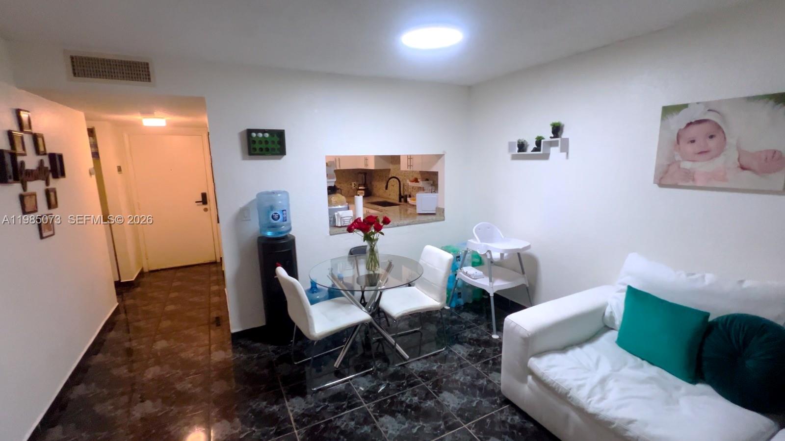 1900 West 68th Street, Unit D207 Hialeah, FL 33014 - Photo 5 of 33 a living room with furniture and wooden floor