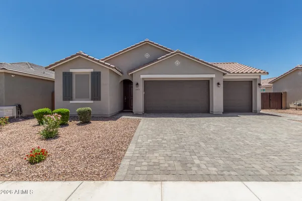 a view of a house with a yard and garage