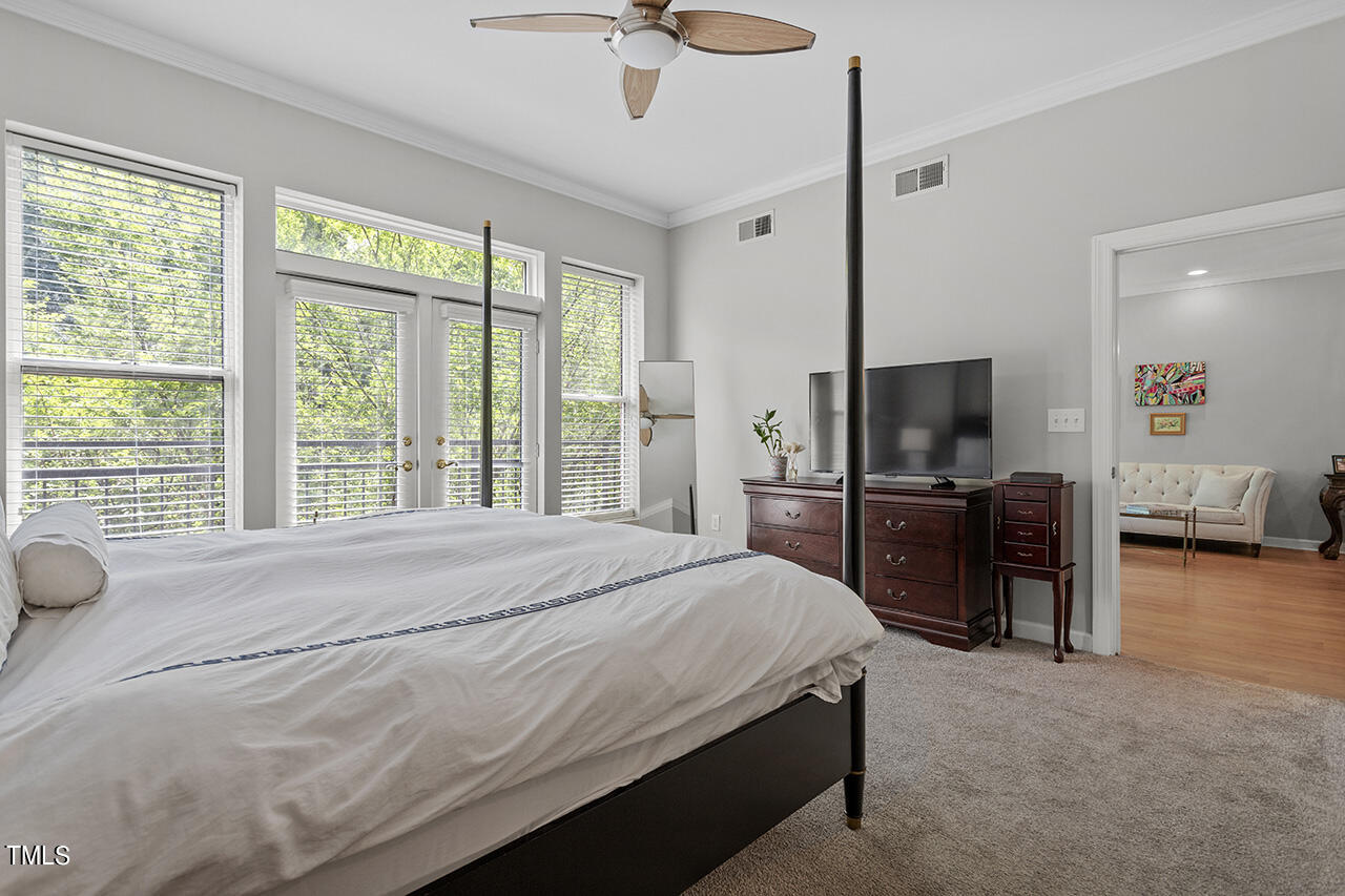 200 South Dawson Street, Unit 203 Raleigh, NC 27601 - Photo 21 of 35 Primary suite
is oversized with Juliet balcony overlooking Nash Square, 3 closets, double bathroom vanities, shower & soaking bathtub.