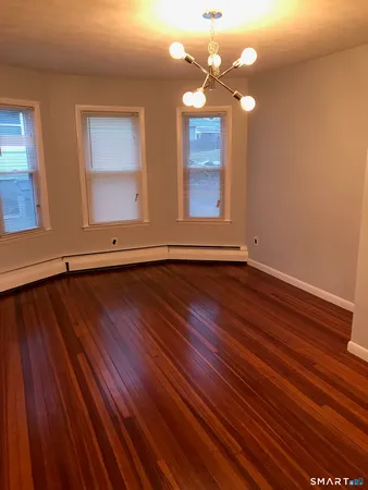 a view of room with window and wooden floor