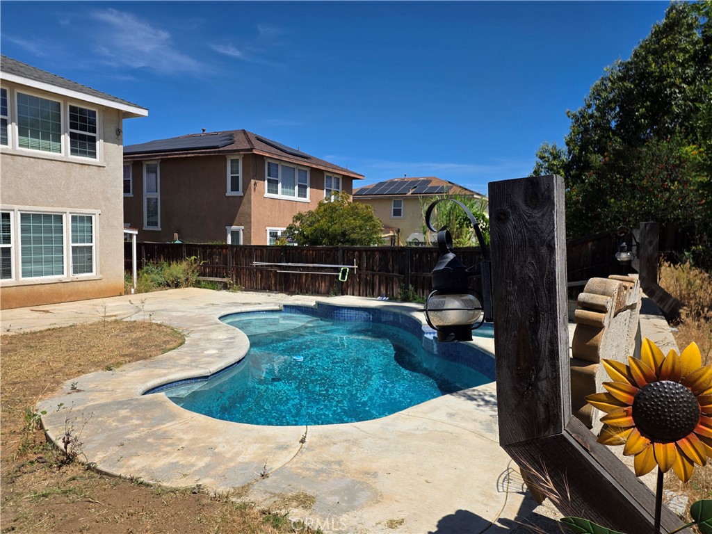 20329 Red Poppy Lane Riverside, CA 92508 - Photo 19 of 24 a view of a house with backyard swimming pool and sitting area