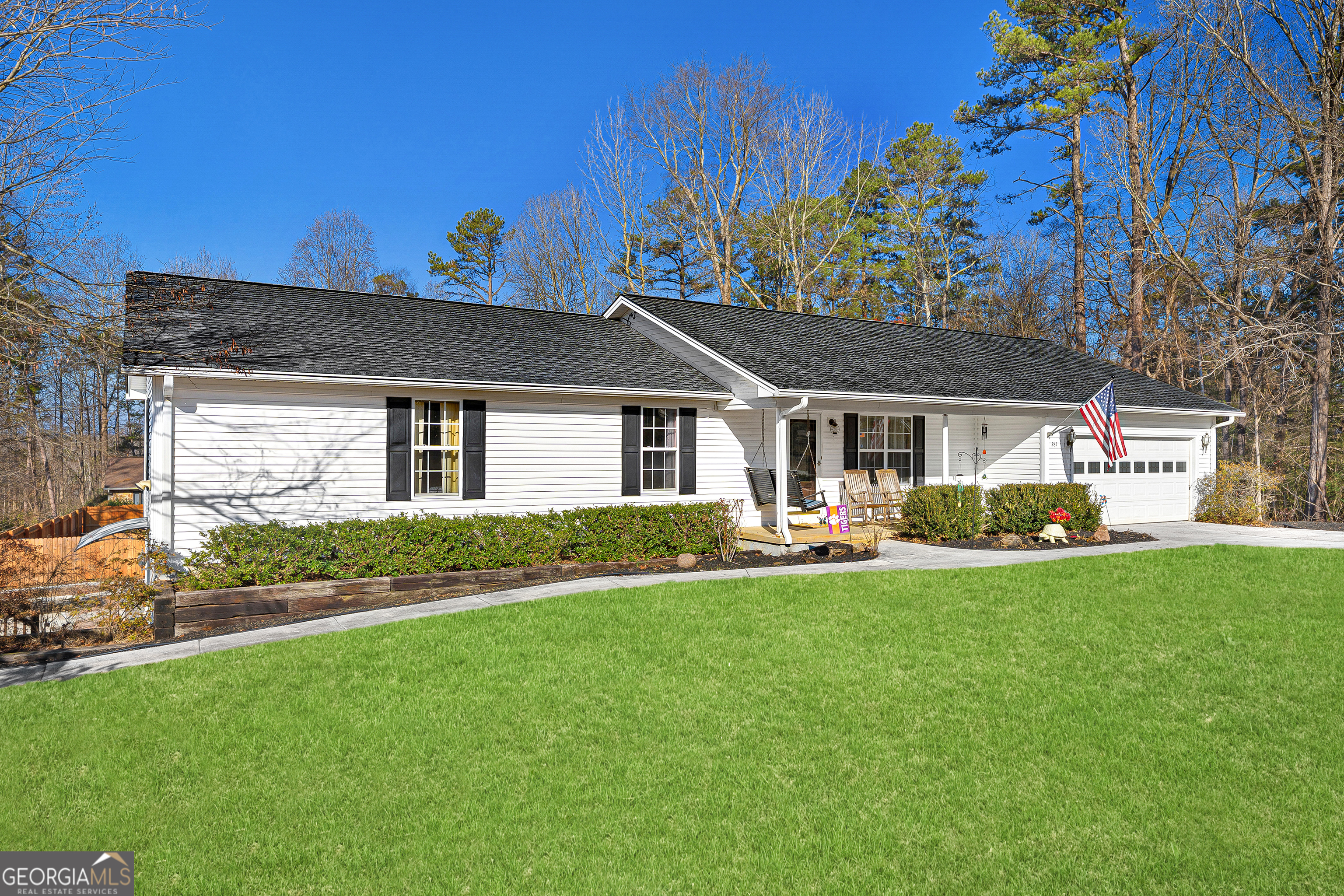 a front view of a house with a garden and plants