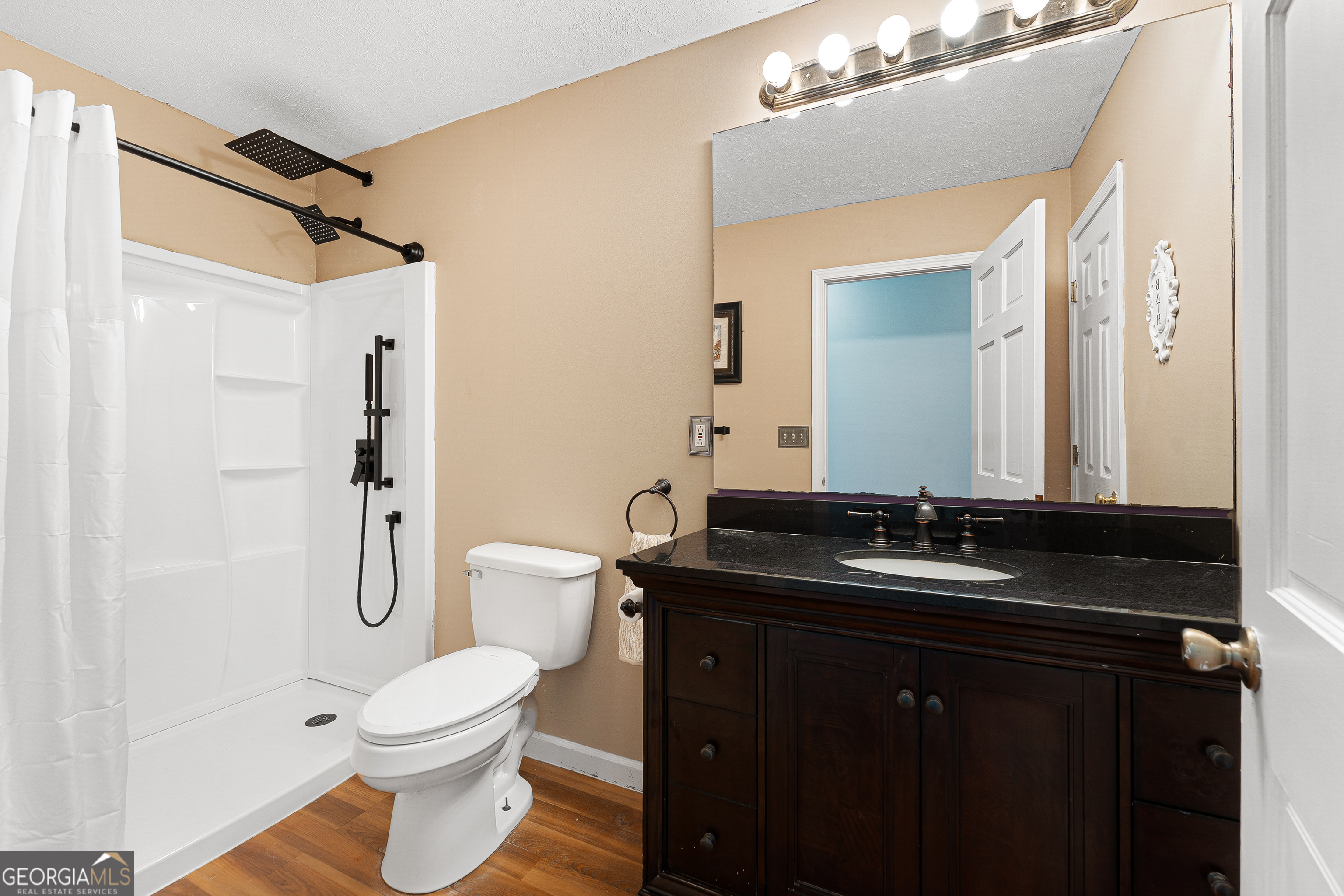 281 Cherokee Drive Fair Play, SC 29643 - Photo 16 of 29 a bathroom with a granite countertop sink toilet a mirror and shower
