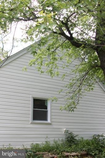 8209 Oakleigh Road Baltimore, MD 21234 - Photo 18 of 27 a side view of a house with a tree