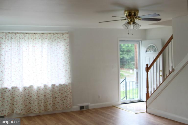 8209 Oakleigh Road Baltimore, MD 21234 - Photo 21 of 27 a view of an empty room with a window and wooden floor