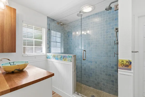 a bathroom with a granite countertop sink a bathtub and shower