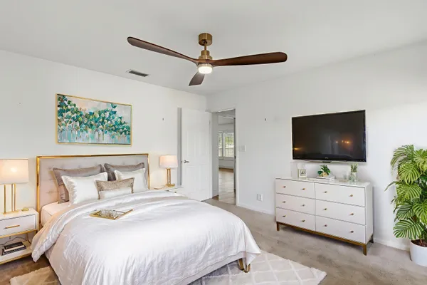 a bedroom with a bed and flat screen tv