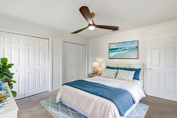 a bedroom with a bed and a painting on the wall