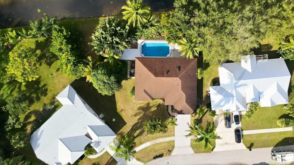 an aerial view of a house with a yard and sitting area