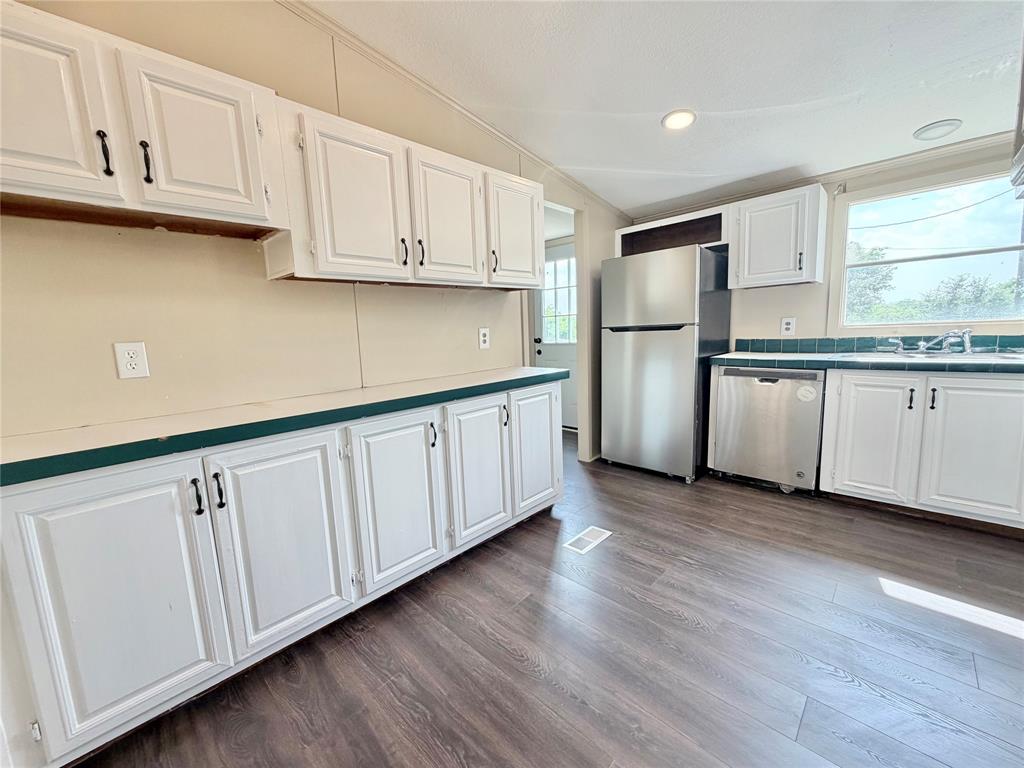 9721 Limestone Joshua, TX 76058 - Photo 14 of 36 a kitchen with stainless steel appliances granite countertop a refrigerator sink and cabinets