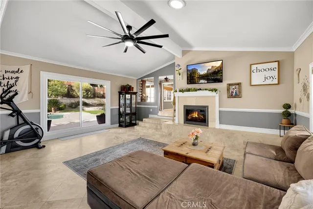 a view of a patio with couches table and chairs under an umbrella with a fire pit