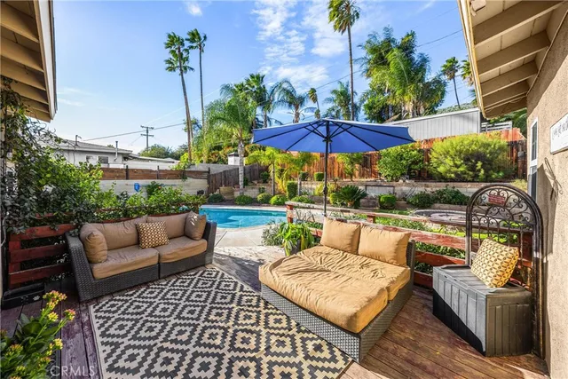 a view of a chair and tables in the patio